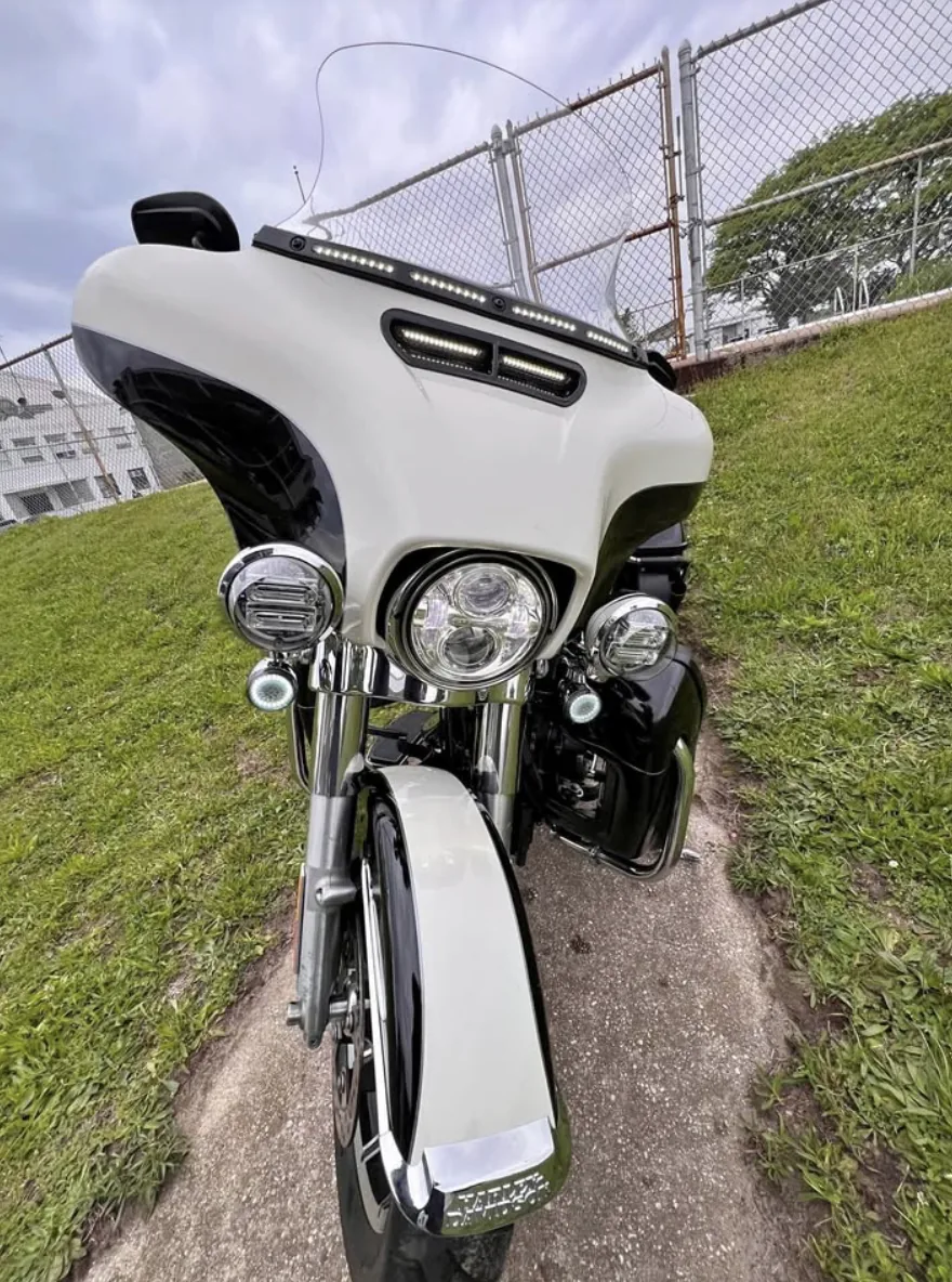 2020 Harley-Davidson Electra Glide in black and cream, front view showing the batwing fairing, LED lighting and chrome fork