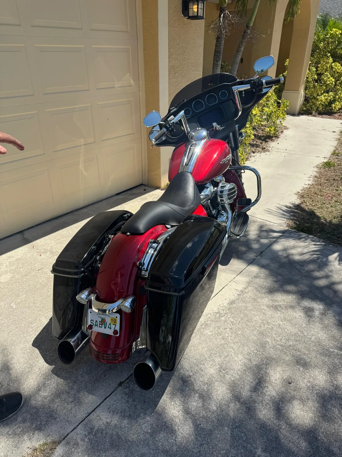 2018 Harley-Davidson Street Glide, candy red with black hard bags, parked in a driveway